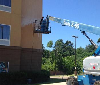Advanced Cleaning Solutions crew cleaning a commercial building exterior